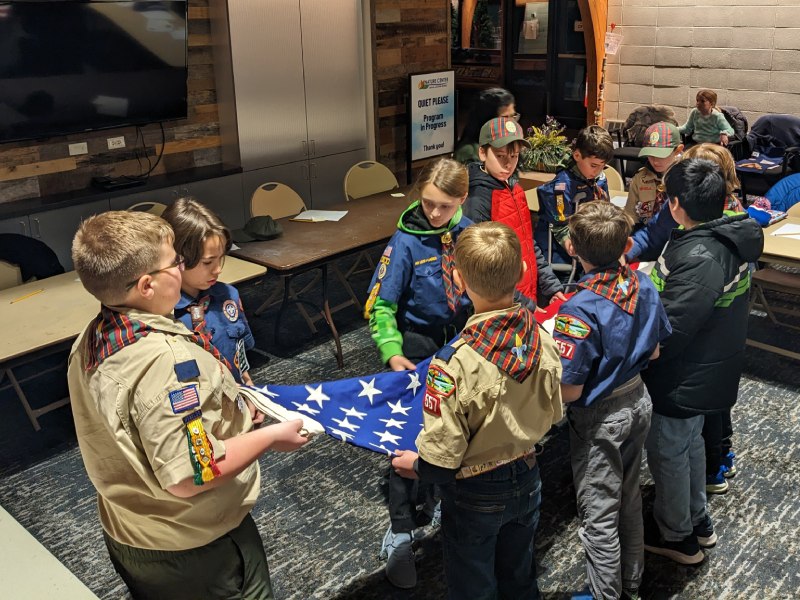 Scouts folding an American flag